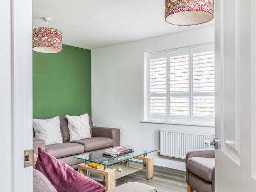 a living room with a couch and a table at Modern Comfortable Home Pass The Keys in Chichester
