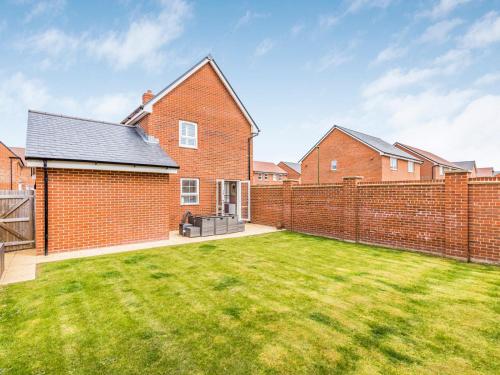 a brick house with a large yard at Modern Comfortable Home Pass The Keys in Chichester