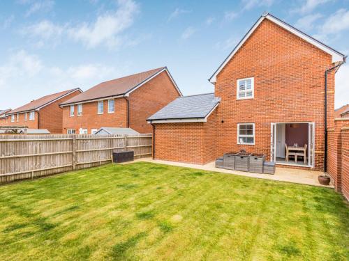 a brick house with a lawn in the yard at Modern Comfortable Home Pass The Keys in Chichester