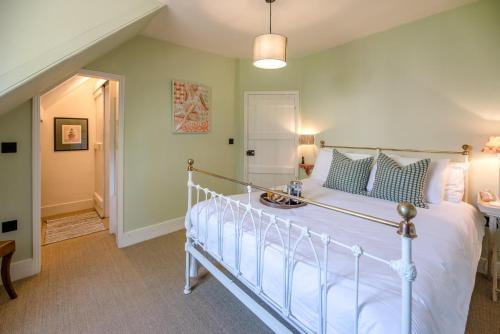 a bedroom with a white bed in a room at Margo's Cottage, Orford in Orford