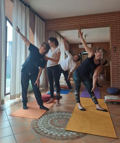 a group of people doing yoga in a room at La dimora di Radha B&B Centro Olistico in Rende