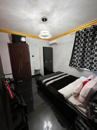 a bedroom with a bed and a chandelier at Apartamenty Południe BB Rico in Bielsko-Biala