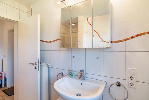 a bathroom with a sink and a mirror at Schwalbenhof Dreßler und Duss für 6 in Bad Herrenalb