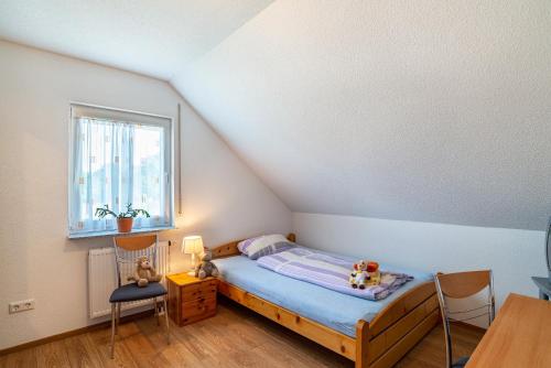 a bedroom with a bed and a table and chairs at Schwalbenhof Dreßler und Duss für 6 in Bad Herrenalb