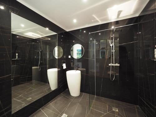 a bathroom with two urinals and a shower at Villa Pauline in Avignon