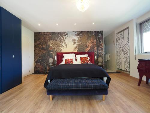 a bedroom with a bed and a painting on the wall at Villa Pauline in Avignon