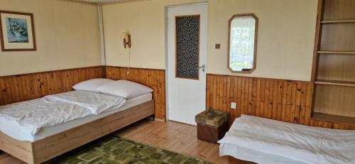 a small bedroom with a bed and a window at Dom Wczasowy Orka in Łazy