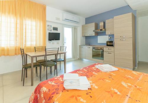 a kitchen and dining room with a bed and a table at Hotel Croce Del Sud in Rimini