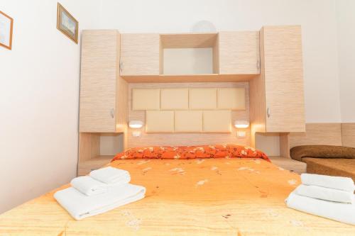 a bedroom with a large bed with two pillows at Hotel Croce Del Sud in Rimini