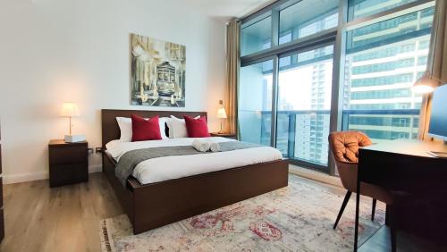 a bedroom with a bed and a large window at Luxe 1BD, boutique apt full lakeview 1m to Metro, Lake & Almas Tower By "La Buena Vida Holiday Homes" in Dubai