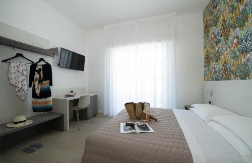 Ένα ή περισσότερα κρεβάτια σε δωμάτιο στο Hotel Pillon