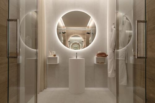 a bathroom with a sink and a mirror at MiHotel Sala in Lyon