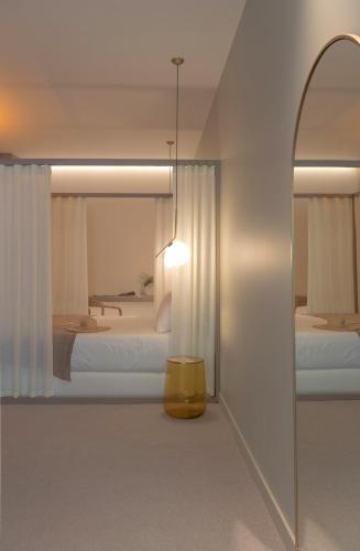 a room with two beds and a mirror at MiHotel Sala in Lyon