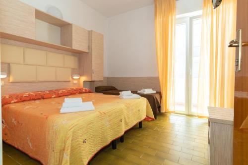 a hotel room with a bed and a window at Hotel Croce Del Sud in Rimini