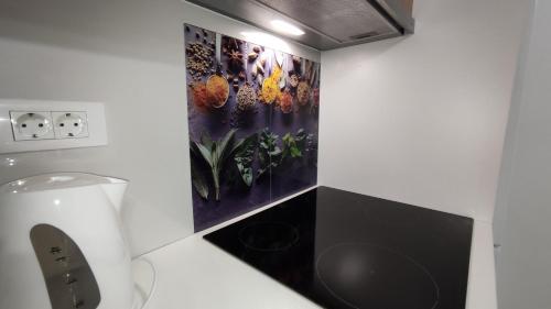 a bathroom with a toilet and a painting on the wall at ADRIATIC APARTMENT center II MAKARSKA in Makarska