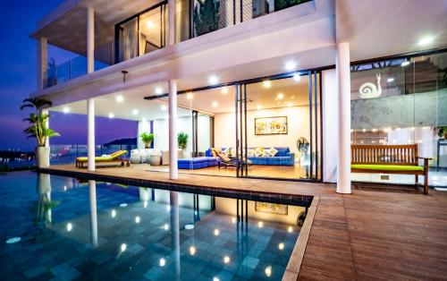 a house with a swimming pool in front of it at Hapier Villa in Nha Trang