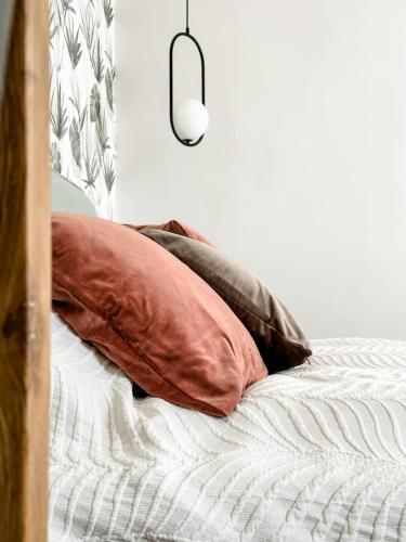 a bed with two pillows on top of it at בקתות שחר in Yonatan