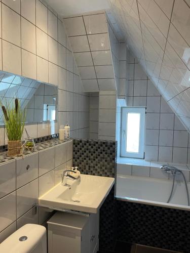 a bathroom with a sink and a toilet and a mirror at Luxury Apartment Amina in Siedlung Schönwalde