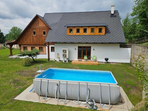 a house with a swimming pool in front of it at Nocuj in Teplice nad Metují