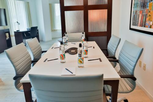 a long table with chairs and bottles on it at Hyatt Place West Palm Beach in West Palm Beach