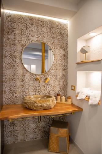 a bathroom with a sink and a mirror at Amelia Apts & Rooms in Alghero