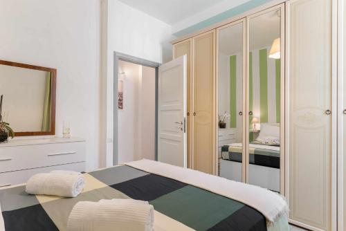 a bedroom with a bed and a mirror at Home Romana Centro Nettuno in Nettuno