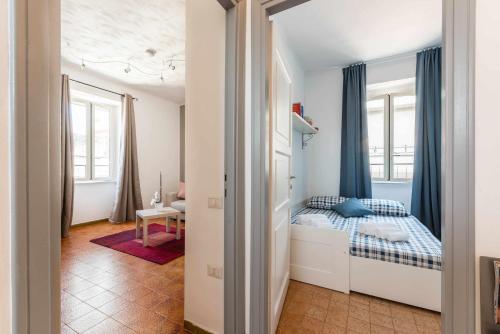 a bedroom with a bed in a room with windows at Home Romana Centro Nettuno in Nettuno