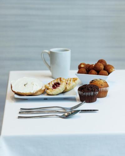 a table with a plate of pastries and a cup of coffee at Hyatt Place West Palm Beach in West Palm Beach