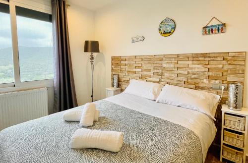 a bedroom with a bed with two pillows on it at Villa loralil by costabravaway in Calonge