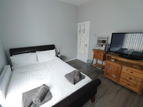 a bedroom with a large bed and a television at Double Room close to EFC LFC Liverpool City Centre in Liverpool