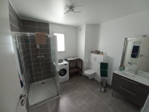 a bathroom with a shower and a washing machine at T2 NEUF ANGLET CENTRE - BIARRITZ in Anglet