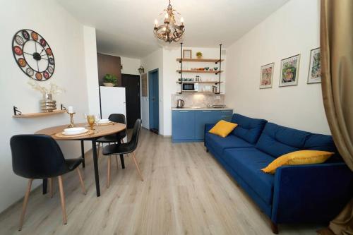 a living room with a blue couch and a table at Design Studio in Atlantis Resort&SPA, Burgas Airport in Burgas City