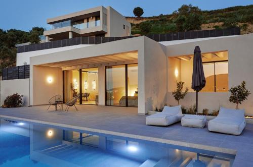 a villa with a swimming pool in front of a house at Althea Lavish Estate - Villa & Suite in Zakynthos