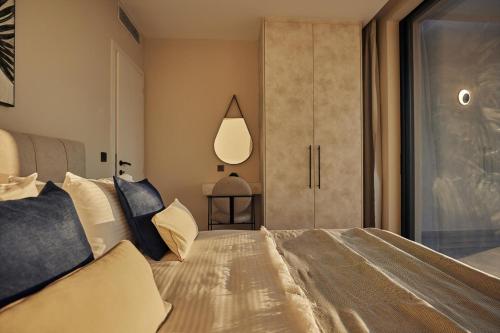 a bedroom with a large bed and a window at Althea Lavish Estate - Villa & Suite in Zakynthos Town