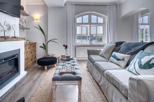 a living room with a couch and a fireplace at The Sand Castle - 2 Bedroom Apartment - Tenby in Tenby