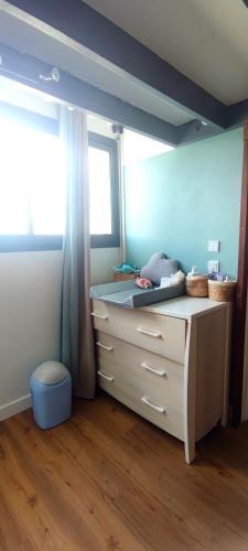 a bedroom with a dresser with a window and a desk at Paradise Duplex avec piscine et accés Plage in Le Gosier