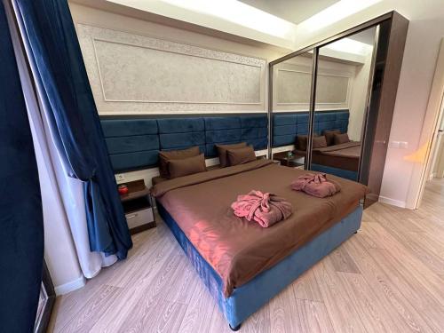 ein Schlafzimmer mit einem großen Bett und einem großen Spiegel in der Unterkunft Sun City Hotel & Spa Naftalan in Naftalan