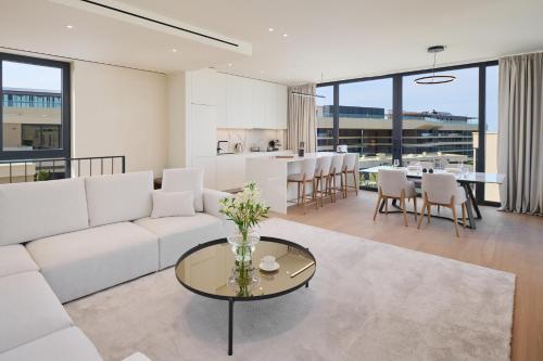 a living room with a white couch and a table at Petram Resort & Residences in Savudrija