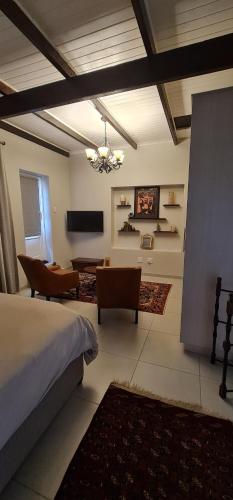 a bedroom with a bed and a living room at Luxury Cottage - Malmesbury in Malmesbury