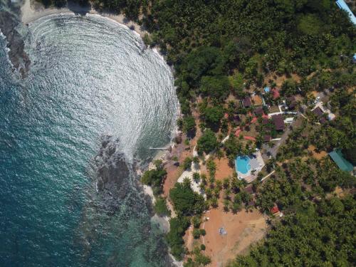 an aerial view of a beach next to the ocean at Adhvasaha Beach Spa Resort in Port Blair