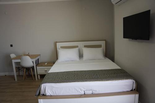 a bedroom with a bed with a tv on the wall at Royal Homes 504 in Antalya