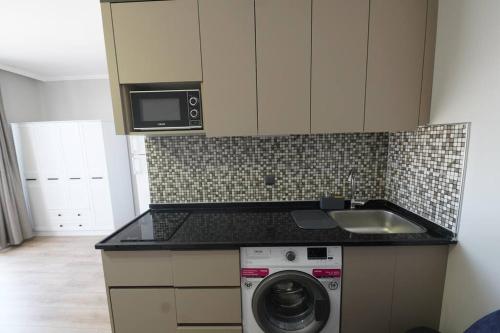 a kitchen with a washing machine and a sink at Royal Homes 504 in Antalya