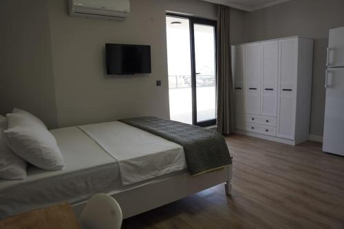 a bedroom with a bed and a tv on the wall at Royal Homes 504 in Antalya