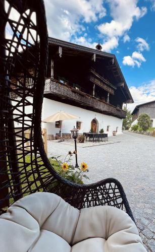 a bench with flowers in front of a building at Chalet Wolfbachgut in Taxenbach