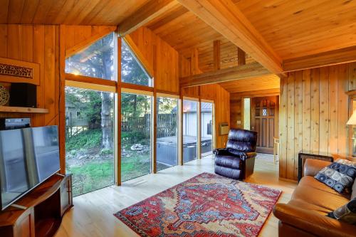 a living room with a couch and a chair and a tv at The Fusion Retreat on 4 Acres Hike On-Site! in White Salmon