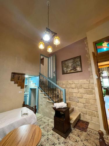 a bedroom with a staircase and a bed and a room at Alf leila wa leila boutique in Haifa