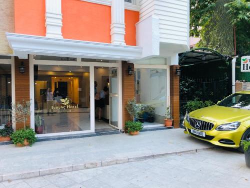 a yellow car parked in front of a store at Turunç Hotel ANTALYA in Antalya
