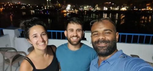 a group of three people posing for a picture at La Terrace in Aswan