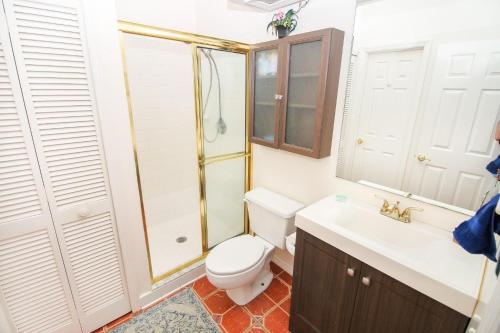 a bathroom with a toilet and a sink and a shower at Ocean Club at Turtle Mound 207 in New Smyrna Beach