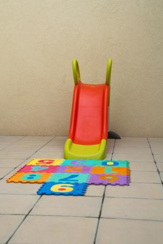 a toy chair sitting on a tiled floor at HAGAH Alojamentos in Guimarães